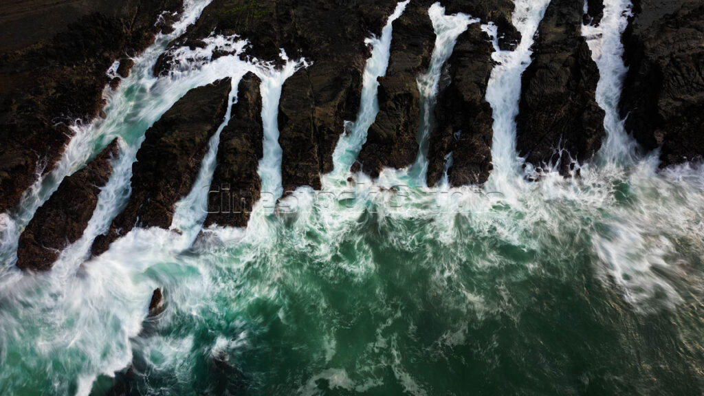 Top view Long exposure powerful Ocean Flow Among the Rocks.