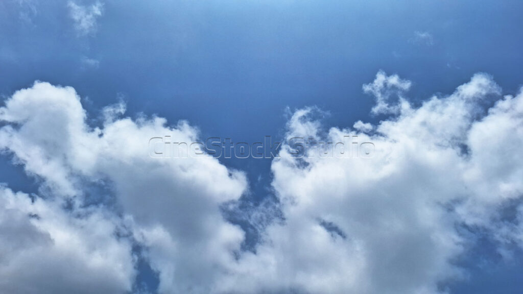 Cotton Clouds Adorning the Bright Blue Sky.