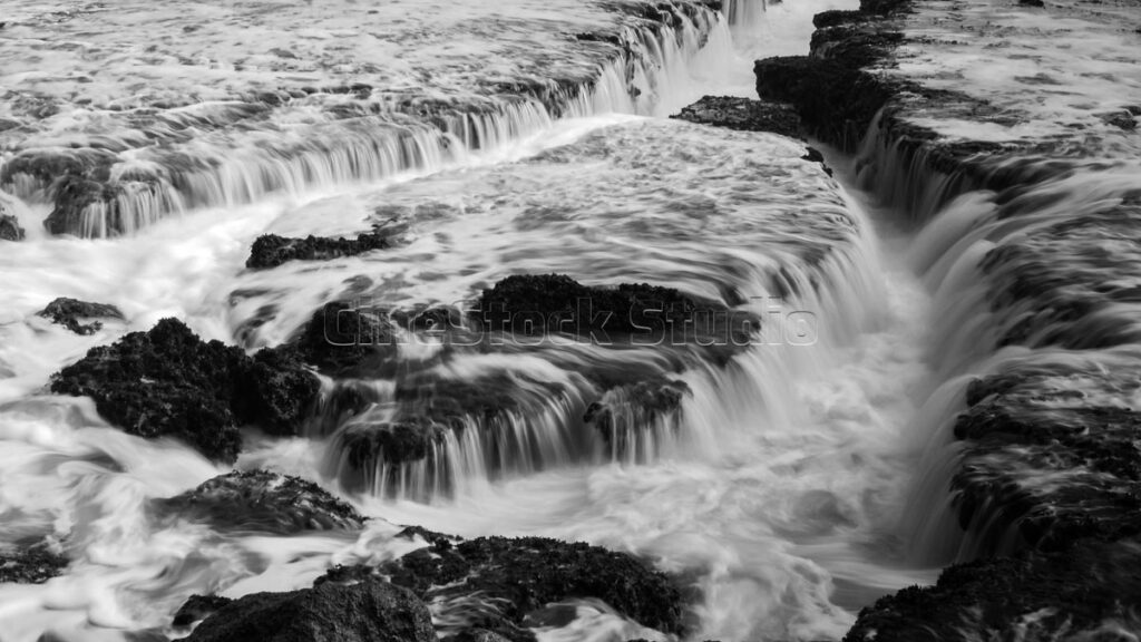 Long exposure mini Waterfall Effect at Karang Bokor Sawarna Beach in Black and White.