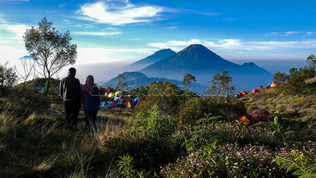 Two climbers are standing enjoying the Beauty of Nature at the Campsite mount Prau.