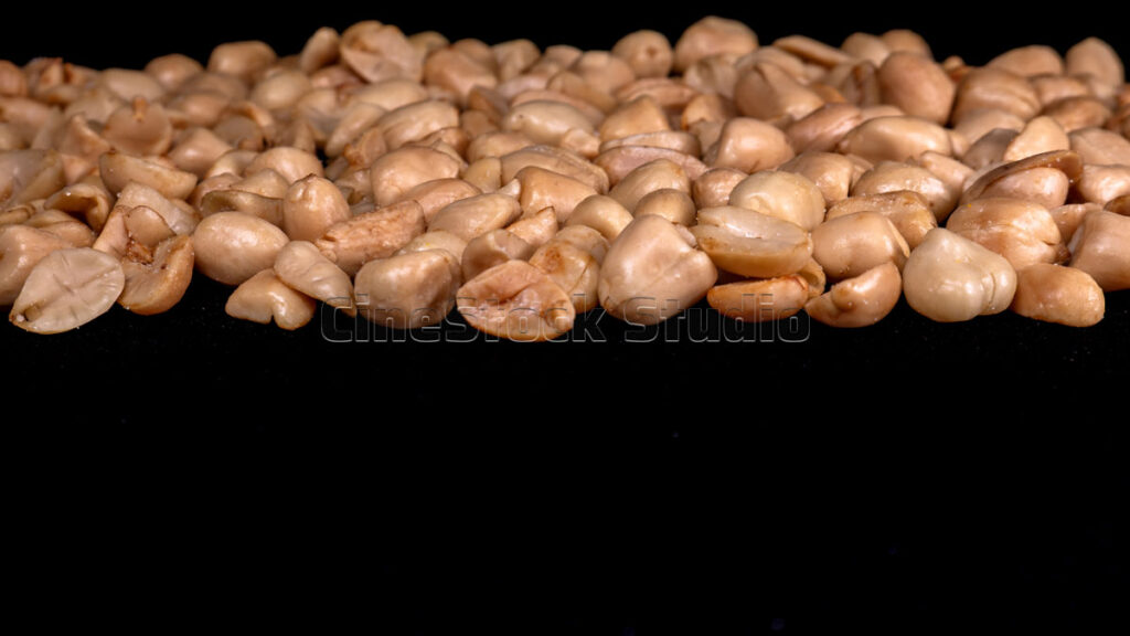 Roasted Peanuts on Black Background With Dramatic Lighting.