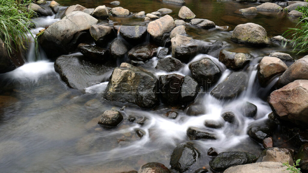 Flowing Water Among Natural Large Rocks.