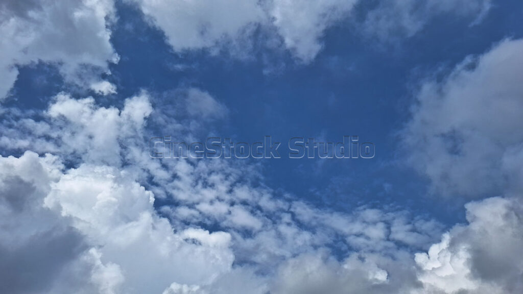 Bright Sky View with Cotton Clouds and blue background.