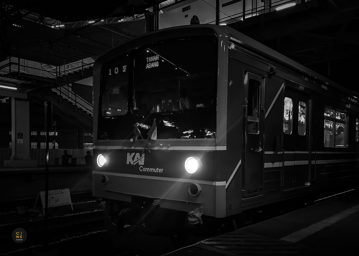 Headlights of a commuter line train arriving at the station.