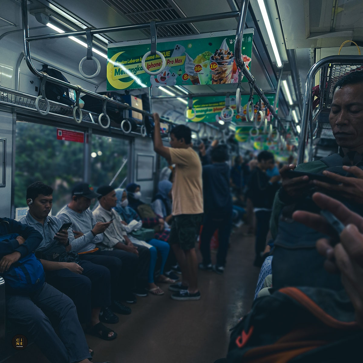 Commuters immersed in their digital worlds inside the train