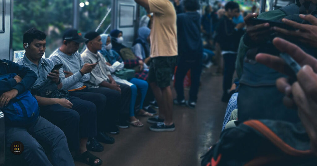 Street Photography A row of passengers sitting and scrolling their digital worlds