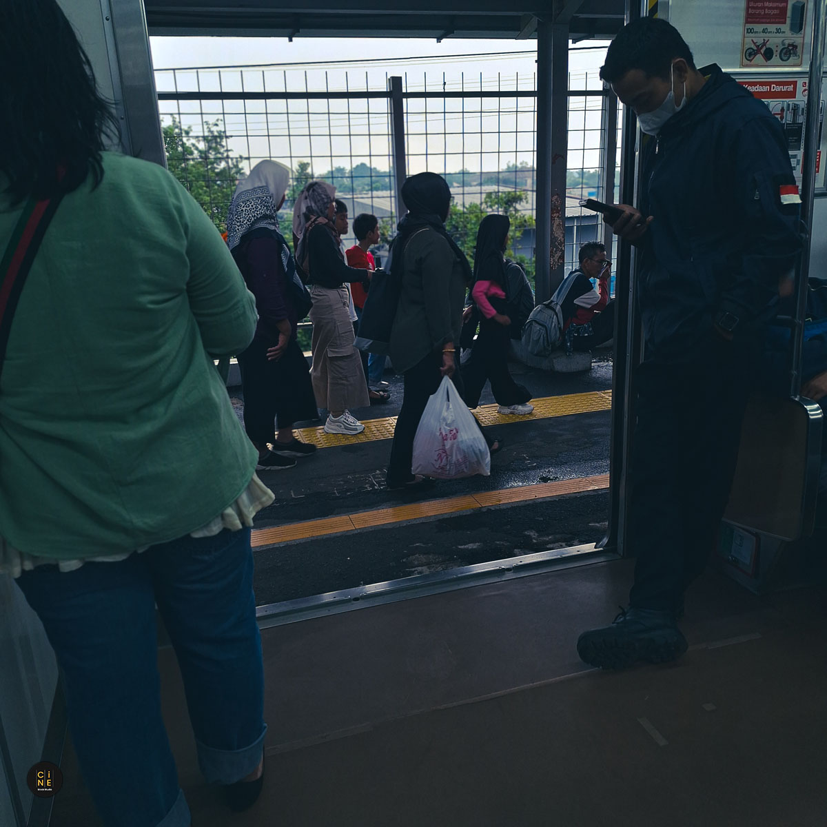 Station platform atmosphere where everyone inhabits digital worlds