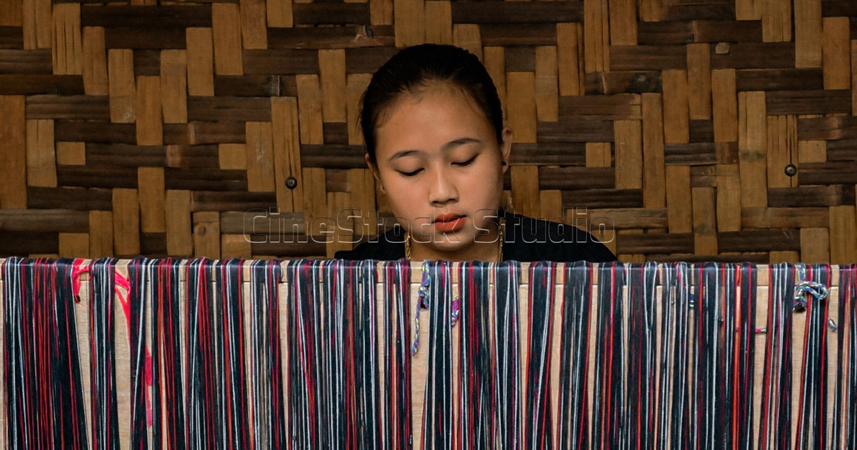Close-up of Baduy Women Weavers & colorful vertical threads on a Baduy loom.
