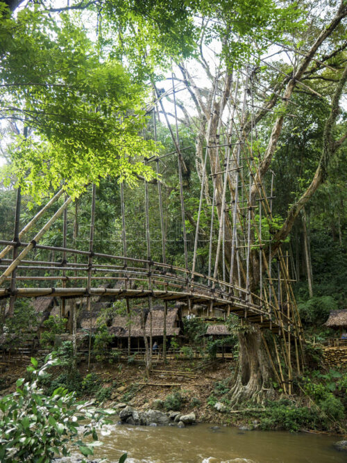 The majestic view of the Gajeboh Bamboo Bridge, the vital connection between the worlds of Outer and Inner Baduy. Wide panoramic shot of Gajeboh bridge crossing the Ciujung river.