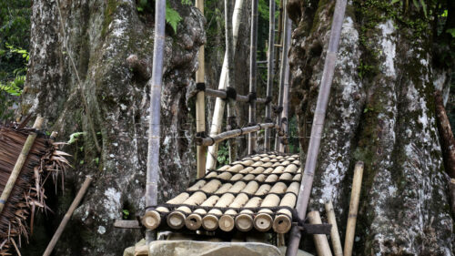 Natural foundations: heavy Ciujung river stones are strategically placed to support the main bamboo pillars of the bridge. Detail of the large river stones used as the foundation of the bridge.