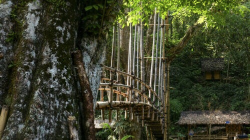 The art of traditional construction: showcasing the intricate rattan ties used to secure the bamboo structure without any metal nails. Close-up of traditional rattan bindings on the bamboo bridge.